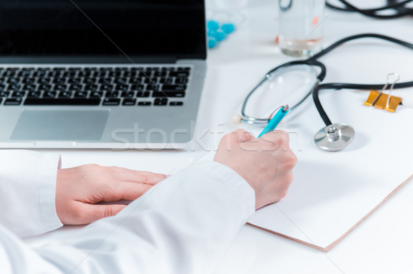 The hands of doctor woman writing at the medical office Stock photo © master1305