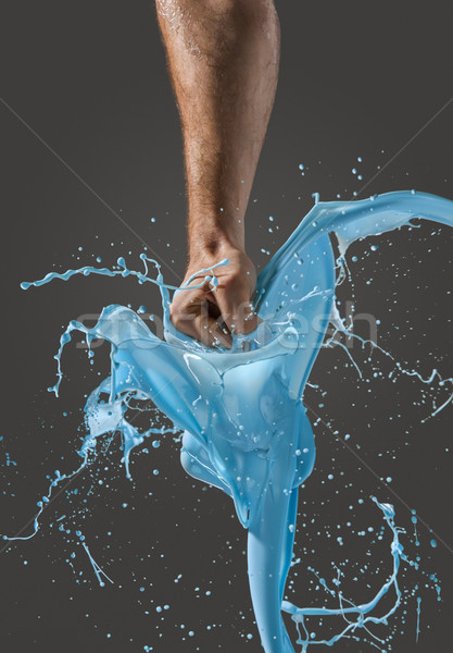 Close-up of a man's fist punching through liquid Stock photo © master1305