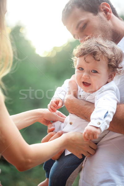Young beautiful father, mother and little toddler son against green trees Stock photo © master1305