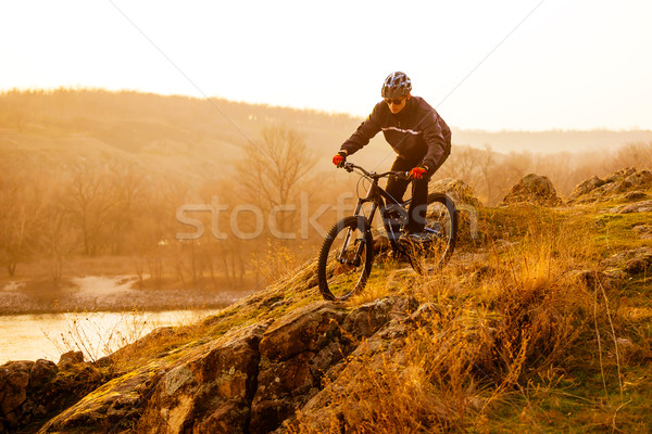 Stock photo: Enduro Cyclist Riding the Mountain Bike Down Beautiful Rocky Trail. Extreme Sport Concept. Space for