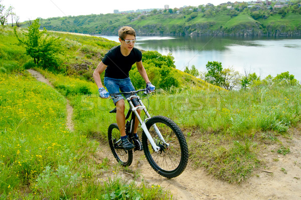 Cyclist Riding the Bike on Beautiful Spring Mountain Trail Stock photo © maxpro