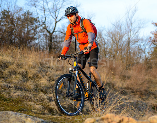 Stock photo: Enduro Cyclist Riding the Mountain Bike on the Rocky Trail. Extreme Sport Concept. Space for Text.