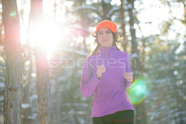 Stock photo: Young Woman Running in Beautiful Winter Forest at Sunny Frosty Day. Active Lifestyle Concept.