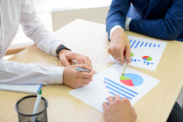 Business People Analyzing Financial Results on Graphs around the Table in Modern Office. Team Work C Stock photo © maxpro