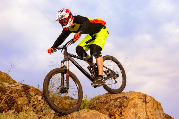 Professional Cyclist Riding the Bike on the Top of the Rock. Extreme Sport Concept. Space for Text. Stock photo © maxpro
