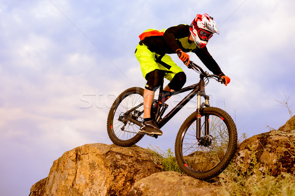 Professional Cyclist Riding the Bike on the Top of the Rock. Extreme Sport Concept. Space for Text. Stock photo © maxpro