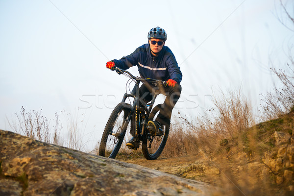Enduro Cyclist Riding the Mountain Bike on the Rocky Trail. Extreme Sport Concept. Space for Text. Stock photo © maxpro