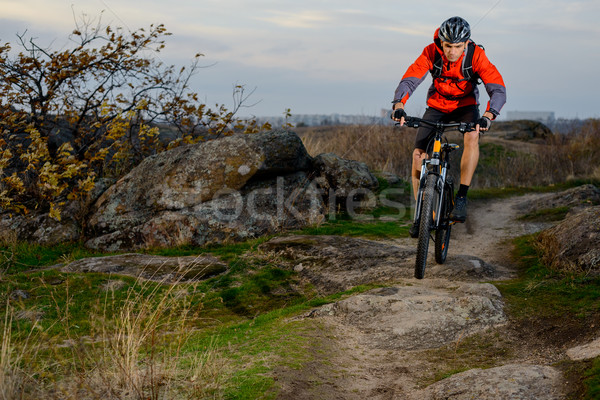 Cyclist in Red Jacket Riding the Bike on Rocky Trail. Extreme Sport. Stock photo © maxpro