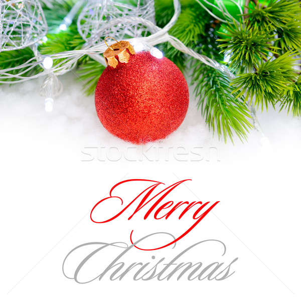 Stock photo: Christmas Decoration with Red Ball, Green Fir Branch and White Lights in Snow. Greeting Card