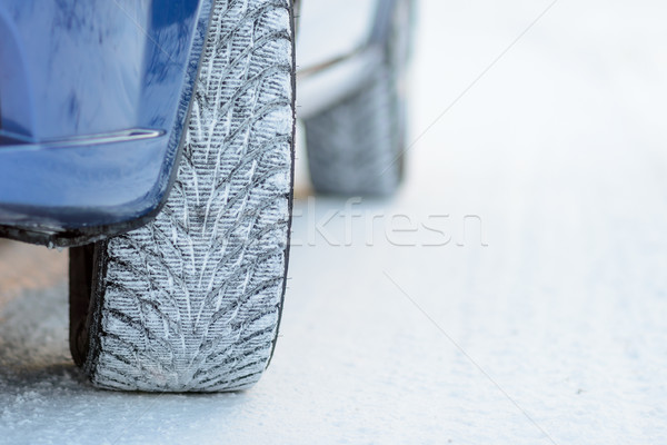 Close-up Image of Winter Car Tire on Snowy Road. Drive Safe Concept. Stock photo © maxpro