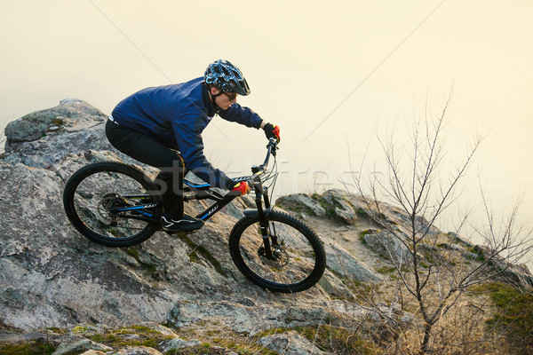 Enduro Cyclist Riding the Mountain Bike on the Rock. Extreme Sport Concept. Space for Text. Stock photo © maxpro