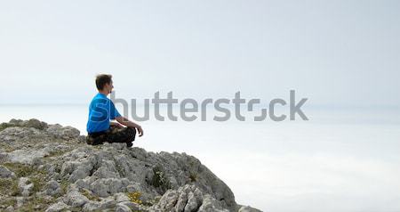 Stock photo: Man Sitting in the Lotus Position on the Rock Above the Sea