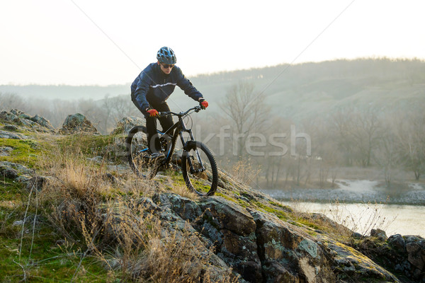 Stock photo: Enduro Cyclist Riding the Mountain Bike Down Beautiful Rocky Trail. Extreme Sport Concept. Space for