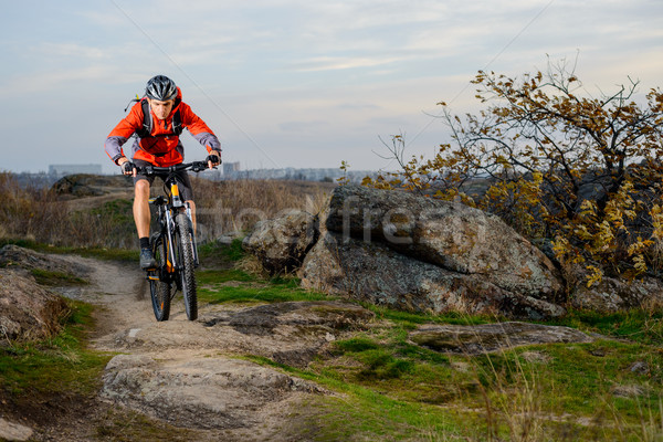 Cyclist in Red Jacket Riding the Bike on Rocky Trail. Extreme Sport. Stock photo © maxpro