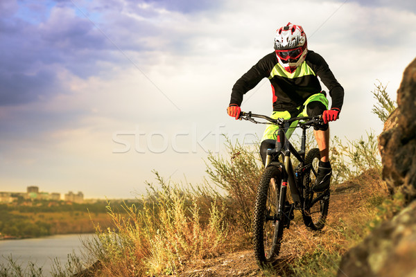 Professional Cyclist Riding the Bike at the Rocky Trail. Extreme Sport Concept. Space for Text. Stock photo © maxpro