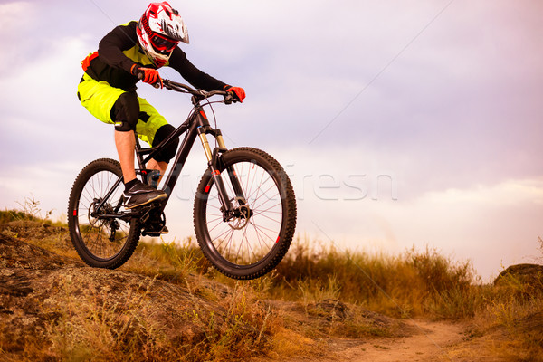 Professional Cyclist Riding the Bike Down Rocky Hill. Extreme Sport Concept. Space for Text. Stock photo © maxpro