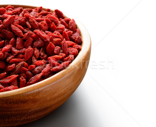 Wooden Bowl Full of Dried Goji Berries on the White Table Stock photo © maxpro