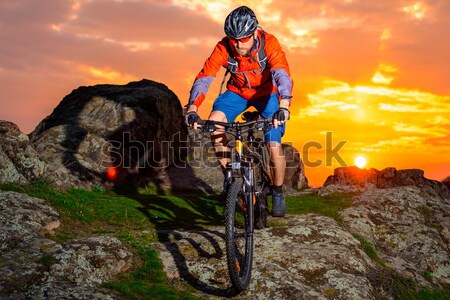 Silhouette of Enduro Cyclist Riding the Mountain Bike on the Rocky Trail at Sunset. Active Lifestyle Stock photo © maxpro