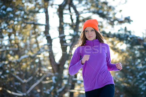 Young Woman Running in Beautiful Winter Forest at Sunny Frosty Day. Active Lifestyle Concept. Stock photo © maxpro