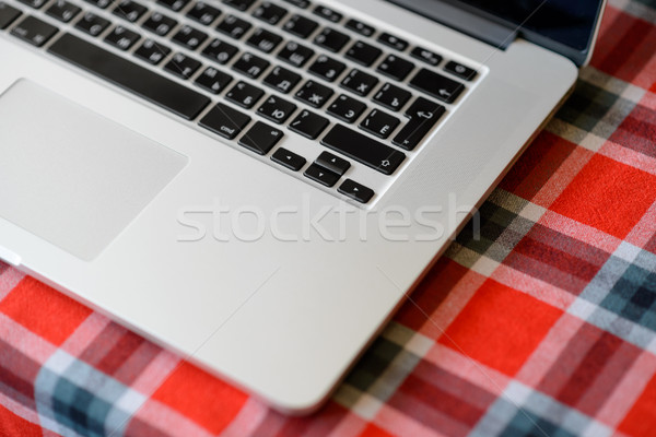 Laptop Computer on the Home Table Covered with Traditional Red Checkered Tablecloth. Top View, Space Stock photo © maxpro