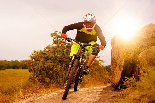 Professional Cyclist Riding the Bike at the Rocky Trail. Extreme Sport Concept. Space for Text. Stock photo © maxpro