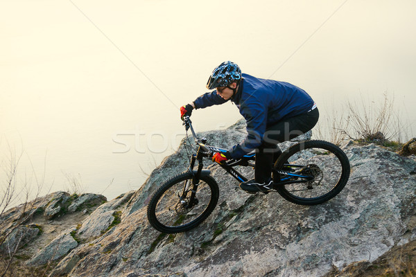 Enduro Cyclist Riding the Mountain Bike on the Rock. Extreme Sport Concept. Space for Text. Stock photo © maxpro