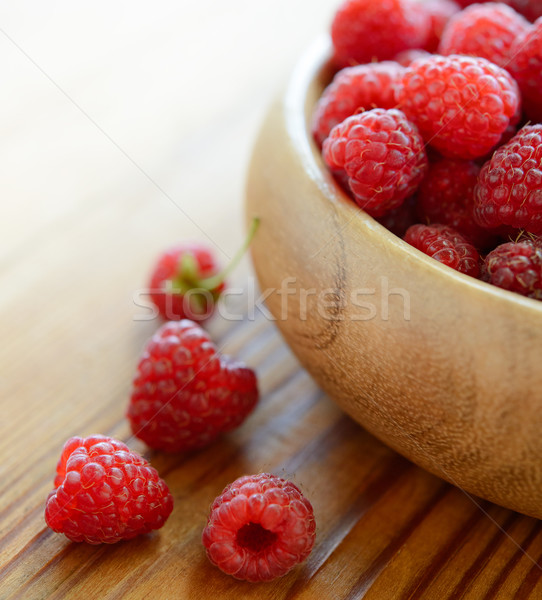 Red Juicy Raspberries in the Wooden Bowl on the Wooden Table Stock photo © maxpro