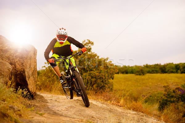 Professional Cyclist Riding the Bike at the Rocky Trail. Extreme Sport Concept. Space for Text. Stock photo © maxpro
