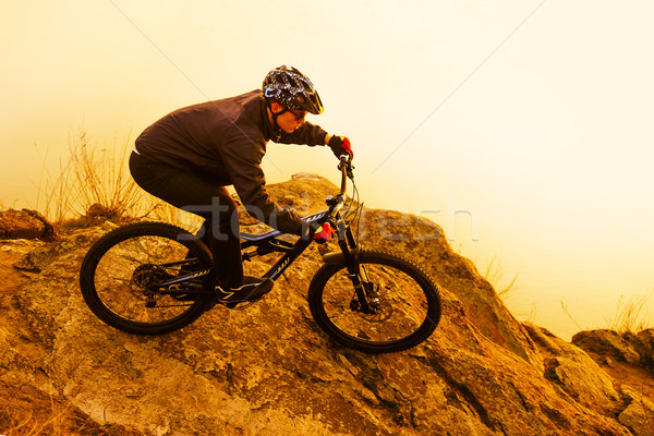 Enduro Cyclist Riding the Mountain Bike on the Rock. Extreme Sport Concept. Space for Text. Stock photo © maxpro