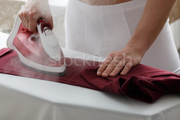 Men ironing his pants Stock photo © maxsol7