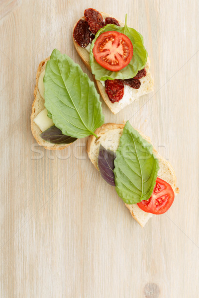 Sandwiches with mascarpone, dried tomatoes, basil Stock photo © maxsol7