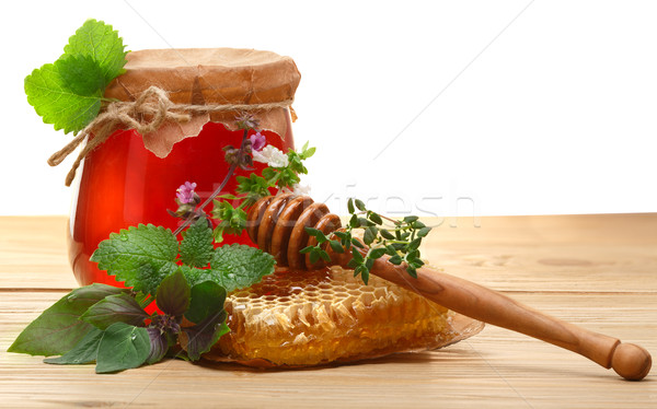 Jar of honey on wooden table Stock photo © maxsol7
