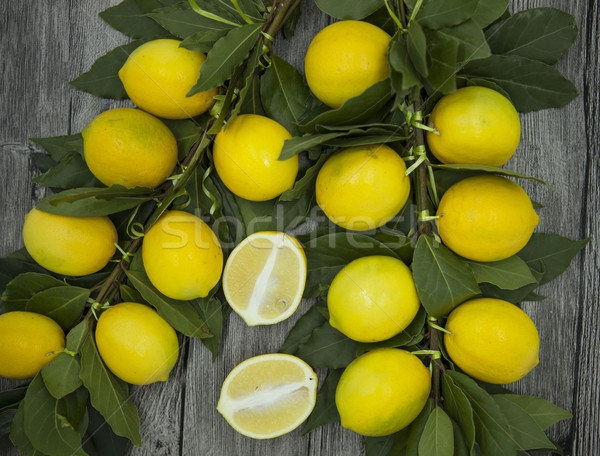Branch of fresh juicy Sicilian lemons on a wooden background Stock photo © mcherevan
