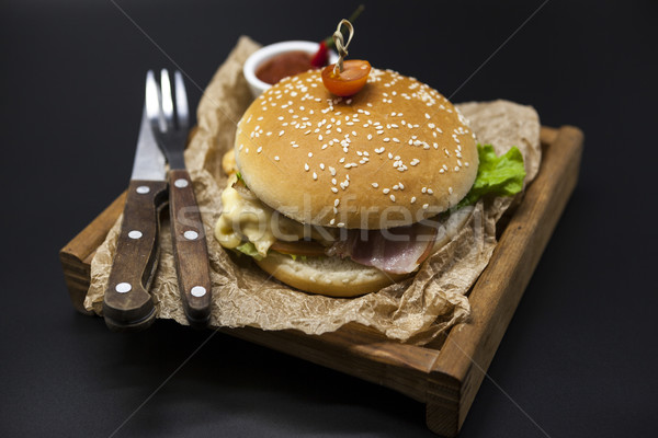 Classical American fresh juicy burger with chicken and ham on a wooden tray with a spicy chili sauce Stock photo © mcherevan