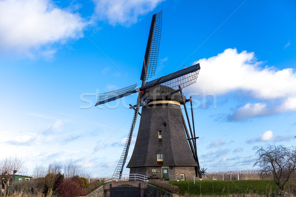 Traditional dutch windmill near the canal. Netherlands. Old windmill stands on the banks of the cana Stock photo © mcherevan