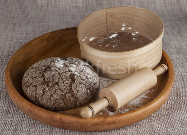 Fresh homemade bread made with a sieve for flour and a rolling pin. Stock photo © mcherevan