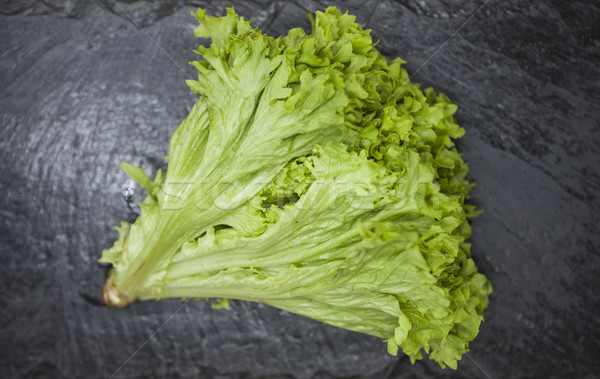 Green fresh bunch of a lettuce on a stone background . The best healthy breakfast for the modern per Stock photo © mcherevan