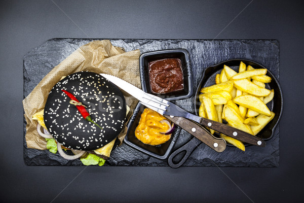 Set of the black burger. Stone plate with: black burger roll slices of juicy marble beef, fused chee Stock photo © mcherevan