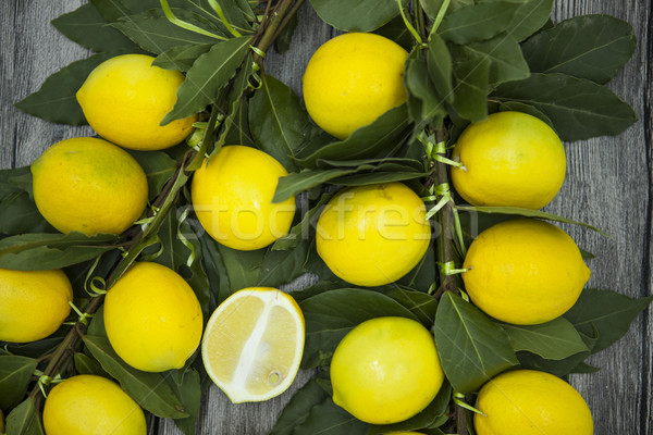 Branch of fresh juicy Sicilian lemons on a wooden background Stock photo © mcherevan