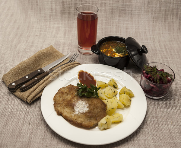 Business lunch : Petite Wiener schnitzel with boiled potatoes and ketchup. Served on a white porcela Stock photo © mcherevan