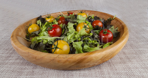 Fresh lettuce and red and yellow cherry tomatoes on a wooden tray Stock photo © mcherevan
