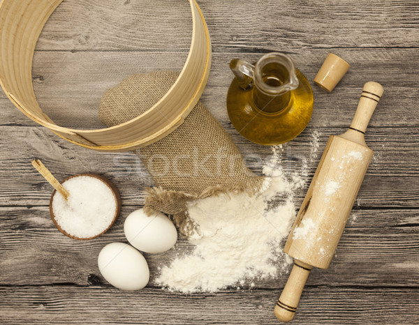 Wheat flour in a canvas bag,sieve, the olive oil in a glass carafe, a large salt shaker wood, raw eg Stock photo © mcherevan