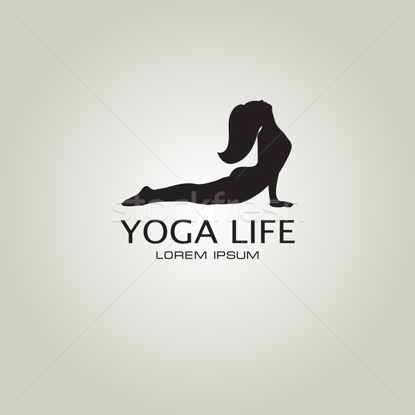 Yoga sign. Girl in yoga pose cobra Stock photo © mcherevan