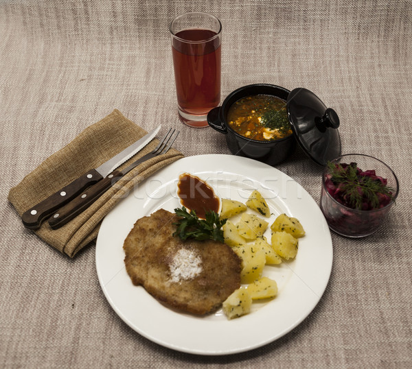 Business lunch : Petite Wiener schnitzel with boiled potatoes and ketchup. Served on a white porcela Stock photo © mcherevan
