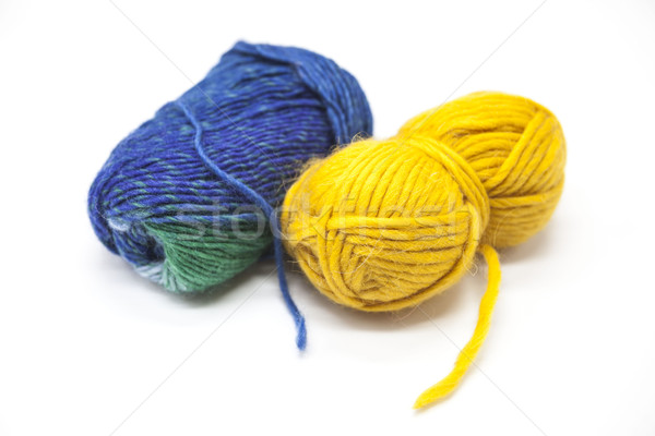 Green blue and  yellow ball of wool yarn for knitting close up on a white background Stock photo © mcherevan