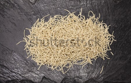 Beautiful homemade Italian pasta from durum wheat on stone background, closeup Stock photo © mcherevan