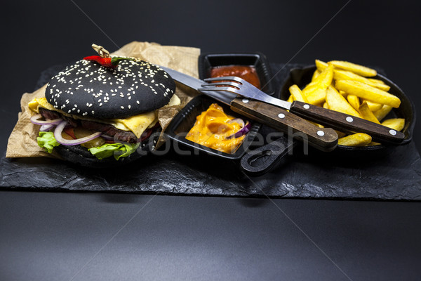 Set of the black burger. Stone plate with: black burger roll slices of juicy marble beef, fused chee Stock photo © mcherevan