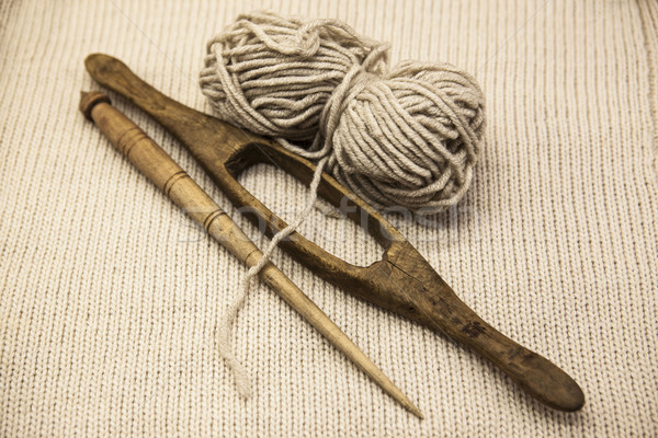 Two old wooden spindle with a ball of wool thread for the manufacture of woolen threads on a tissue  Stock photo © mcherevan