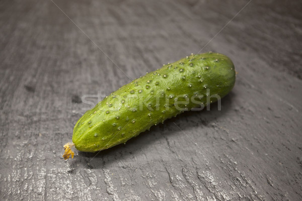 Fresh appetizing tasty cucumber on a stone background. Stock photo © mcherevan