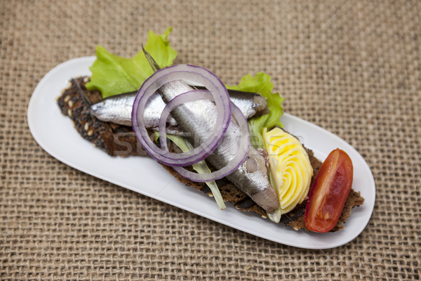 Delicious Spanish tapas with butter and onion salad sprat, Atlantic on slice baguette. An excellent  Stock photo © mcherevan